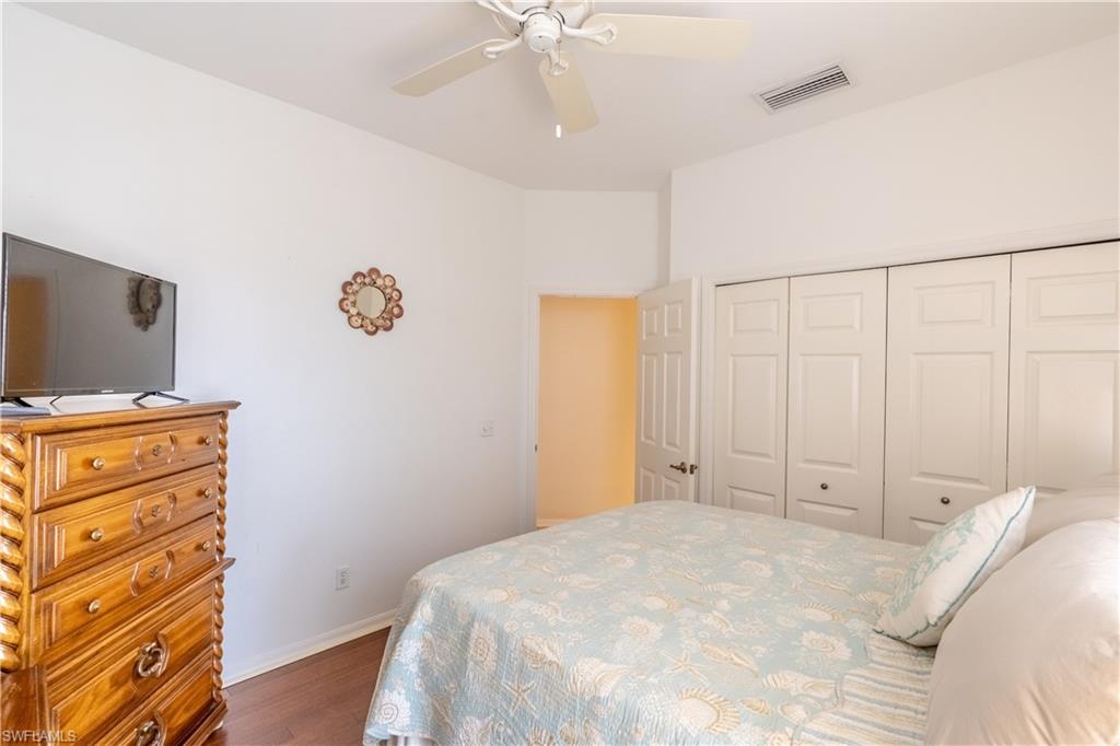 431 Crossfield Circle, Unit 77 Naples, FL 34104 - Photo 17 of 33 a bedroom with a bed and a flat tv screen on dresser