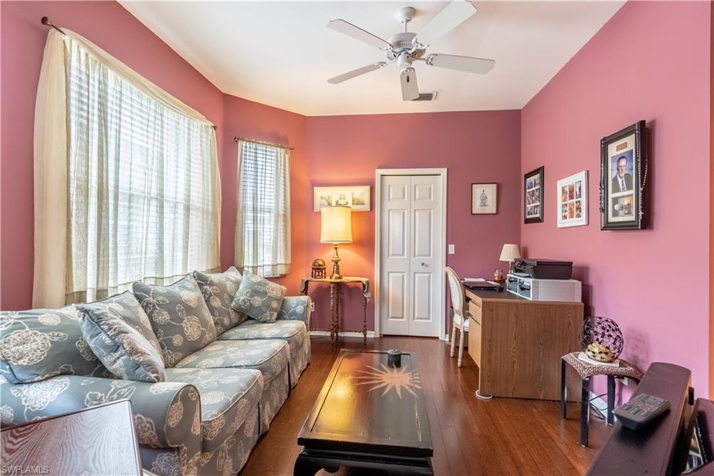 431 Crossfield Circle, Unit 77 Naples, FL 34104 - Photo 20 of 33 a living room with furniture and wooden floor