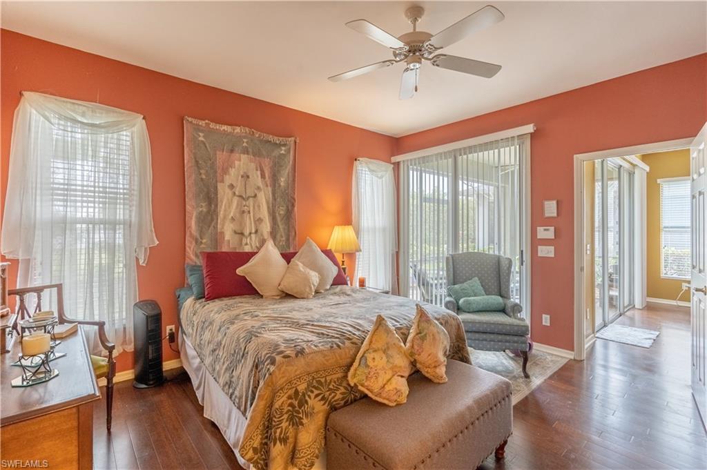 431 Crossfield Circle, Unit 77 Naples, FL 34104 - Photo 21 of 33 a bedroom with a bed and wooden floor