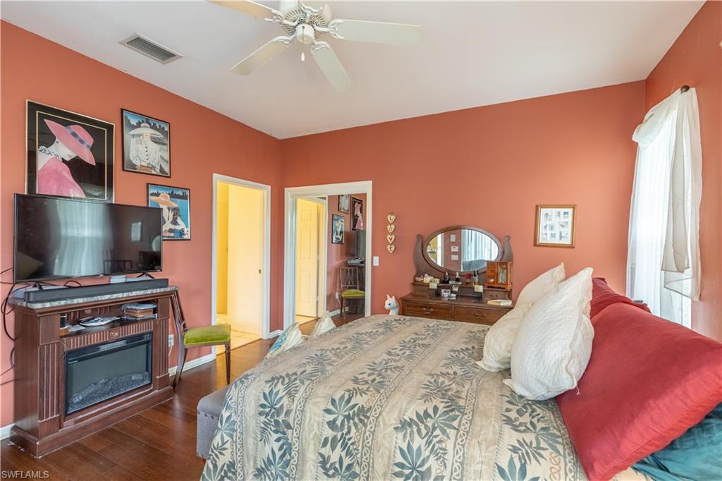 431 Crossfield Circle, Unit 77 Naples, FL 34104 - Photo 22 of 33 a bedroom with furniture and a flat screen tv