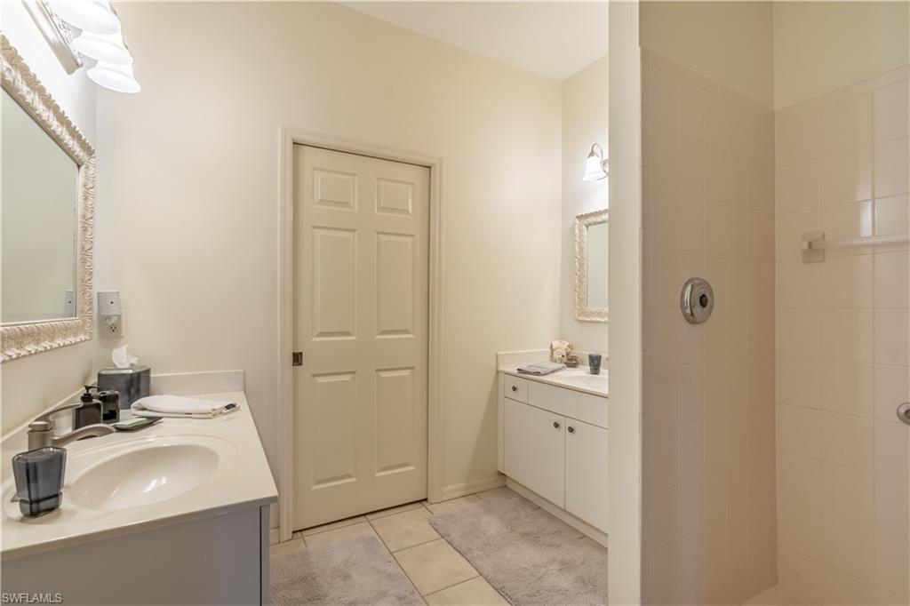 431 Crossfield Circle, Unit 77 Naples, FL 34104 - Photo 24 of 33 a bathroom with a sink and a mirror