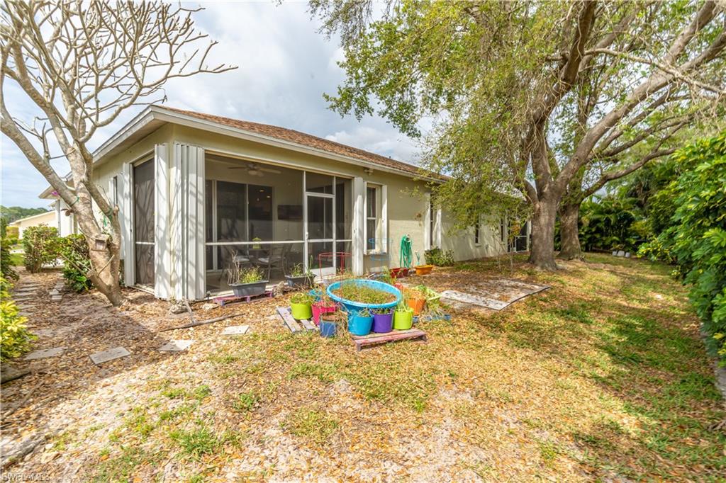 431 Crossfield Circle, Unit 77 Naples, FL 34104 - Photo 29 of 33 a front view of a house with garden