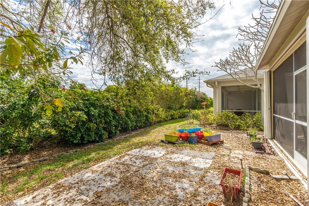 431 Crossfield Circle, Unit 77 Naples, FL 34104 - Photo 30 of 33 a garden view with a seating space