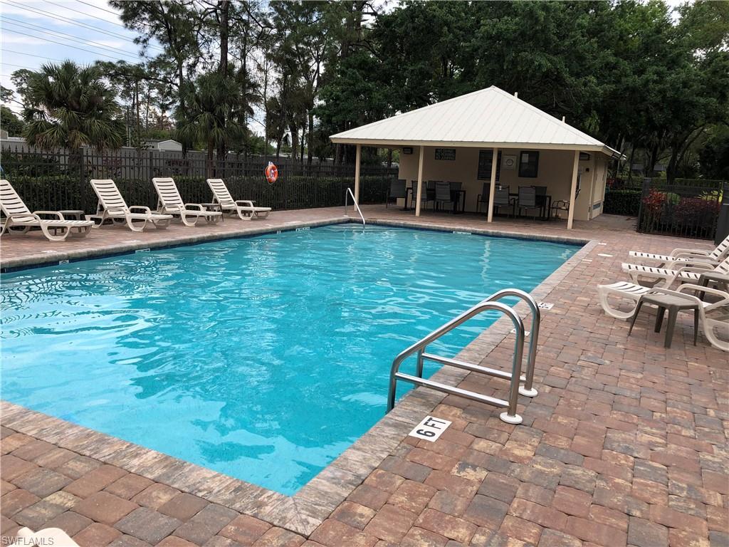 431 Crossfield Circle, Unit 77 Naples, FL 34104 - Photo 33 of 33 a view of a house with backyard porch and sitting area