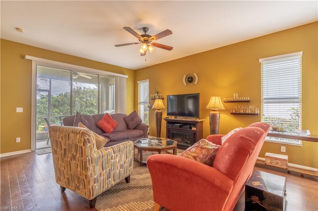 431 Crossfield Circle, Unit 77 Naples, FL 34104 - Photo 6 of 33 a living room with furniture a large window and a flat screen tv