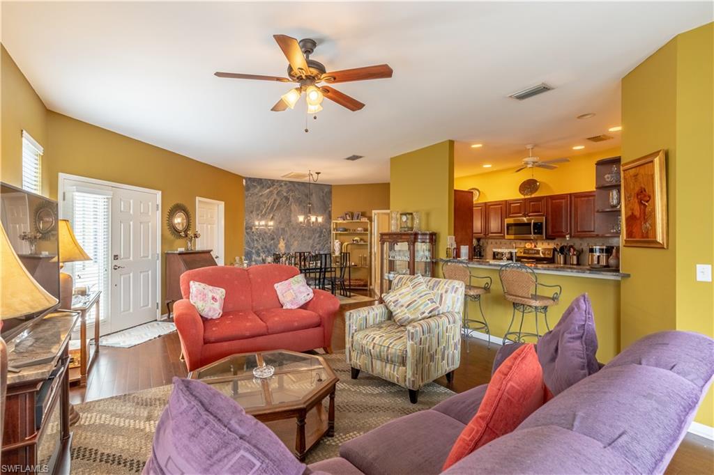 431 Crossfield Circle, Unit 77 Naples, FL 34104 - Photo 8 of 33 a living room with furniture kitchen view and a large window