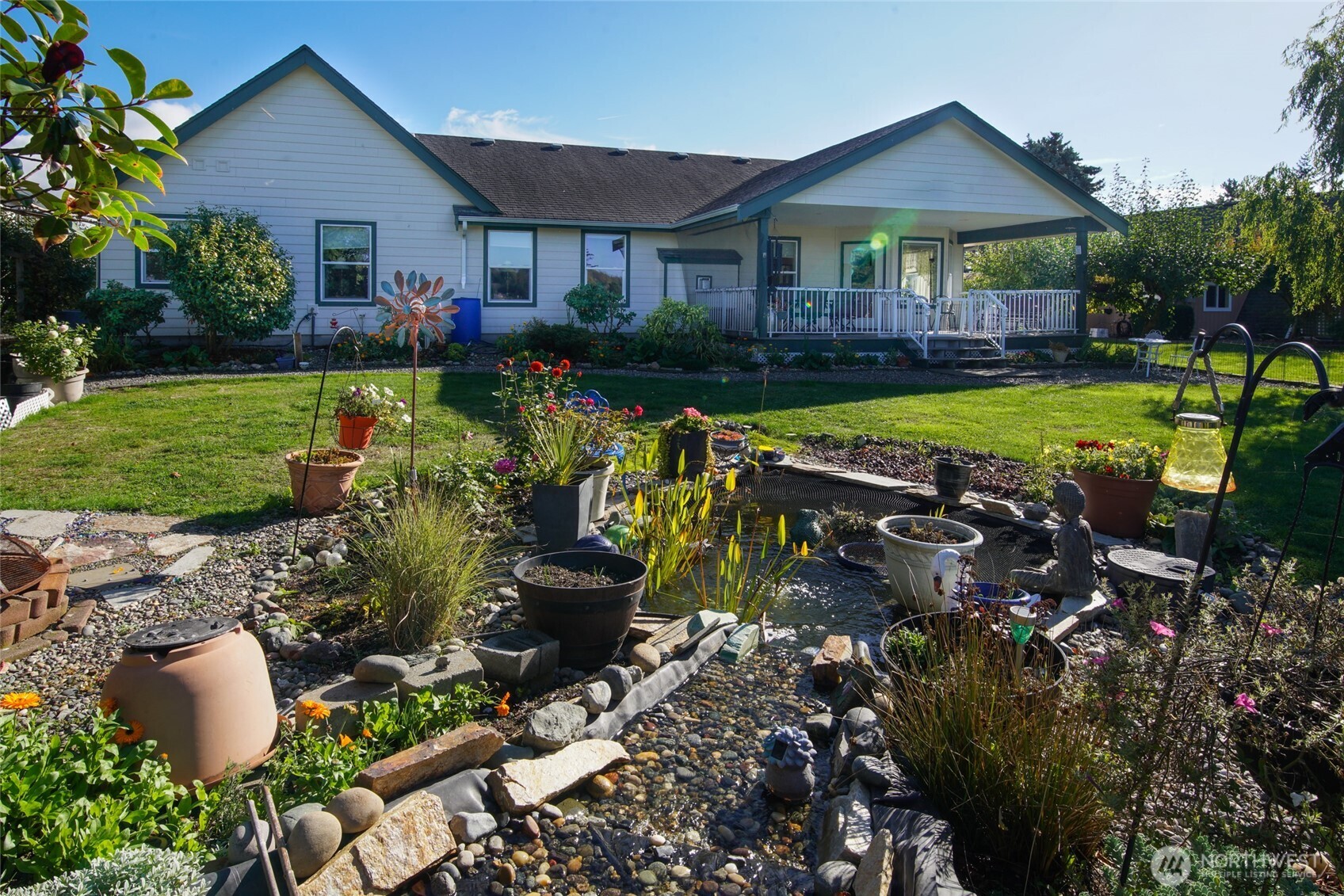 8137 Cowichan Road Blaine, WA 98230 - Photo 26 of 40 a view of a house with a yard and a garden