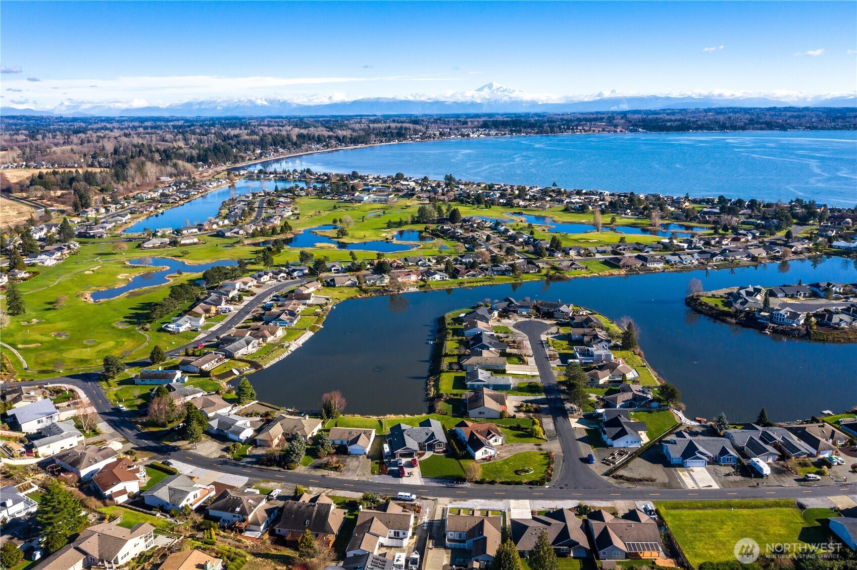 8137 Cowichan Road Blaine, WA 98230 - Photo 39 of 40 an aerial view of a city with lots of residential buildings and ocean view in back