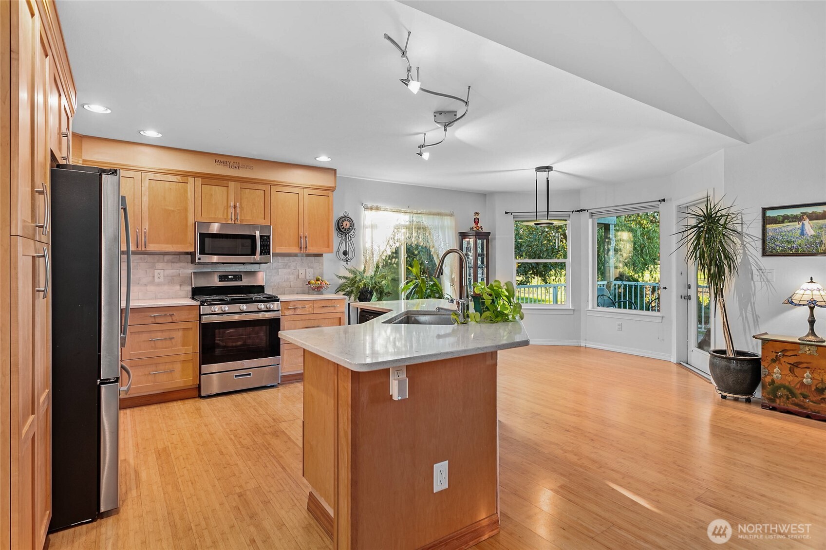 8137 Cowichan Road Blaine, WA 98230 - Photo 8 of 40 a kitchen with stainless steel appliances kitchen island granite countertop a stove and a refrigerator