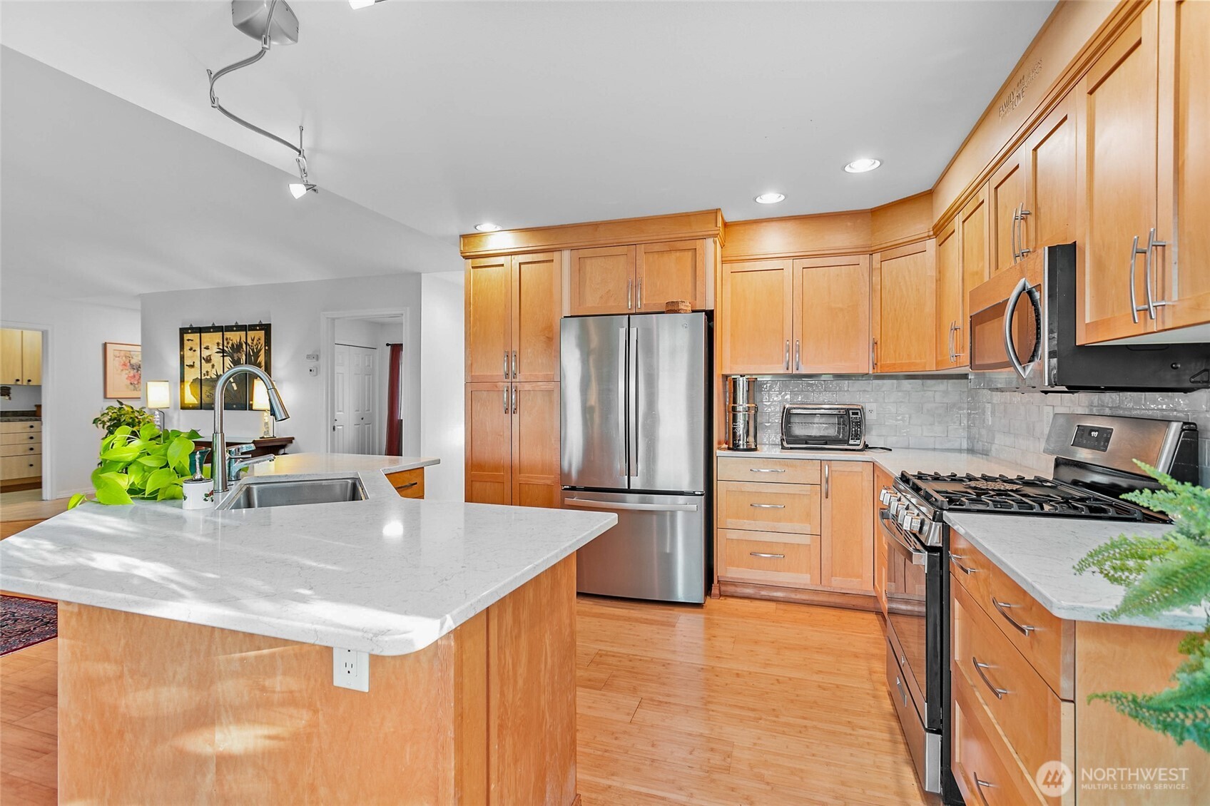 8137 Cowichan Road Blaine, WA 98230 - Photo 10 of 40 a kitchen with stainless steel appliances granite countertop a sink a stove and a refrigerator