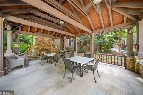 a view of a patio with a table chairs and a backyard