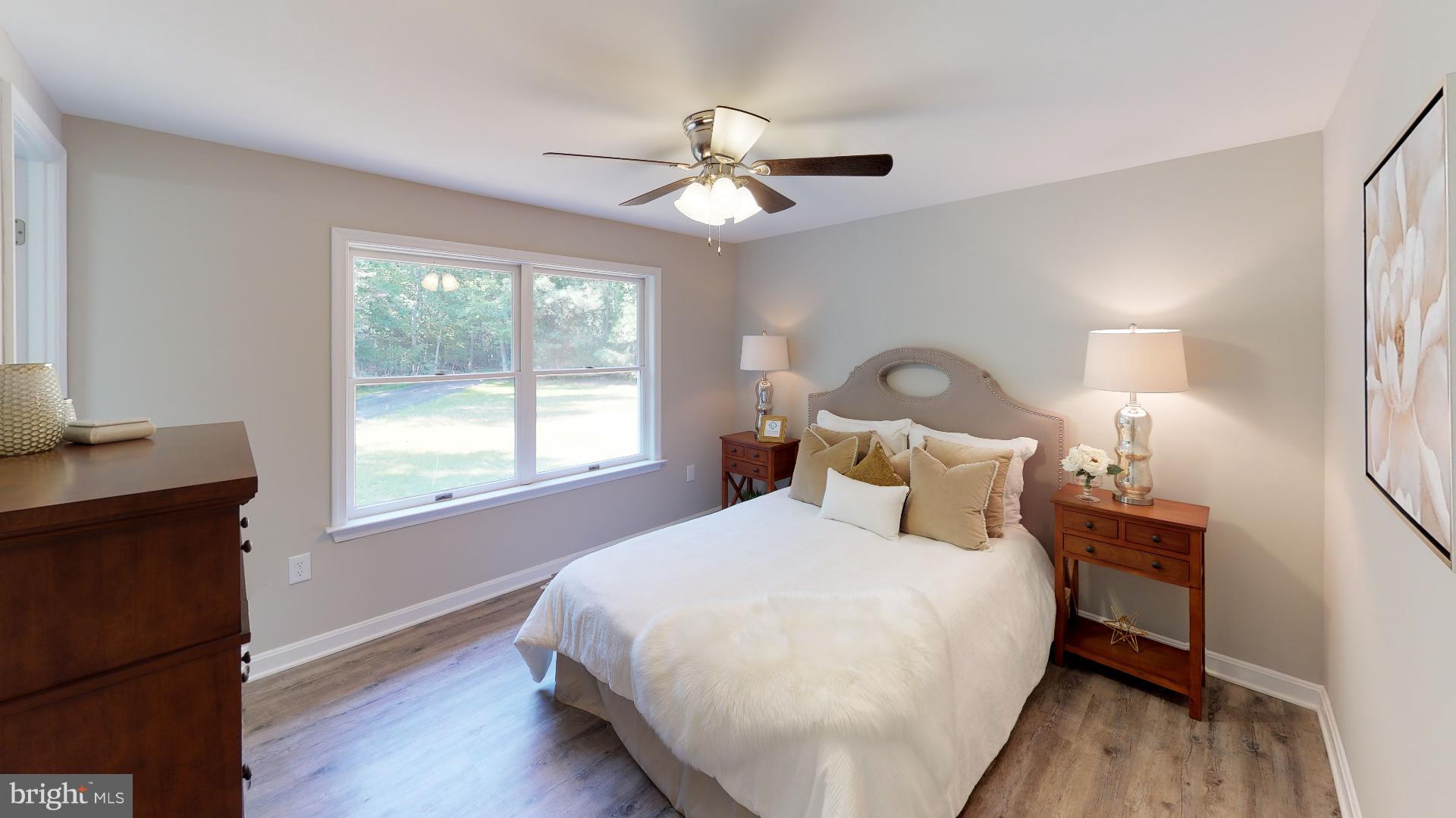 13284 Joy Road Lusby, MD 20657 - Photo 13 of 29 a bedroom with a bed window and wooden floor