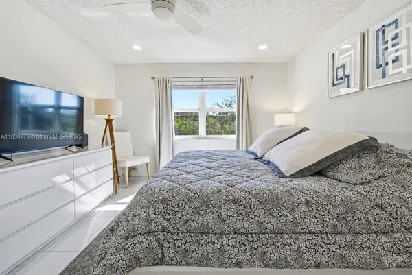 a bedroom with a large bed and a dresser