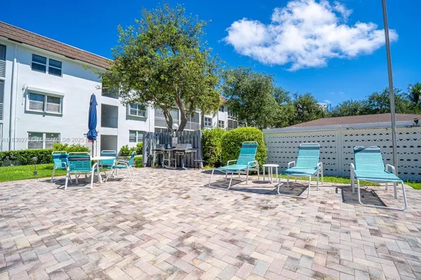 a lawn chairs and a table in a backyard
