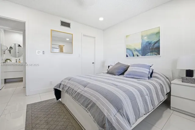 a bedroom with a bed and a television