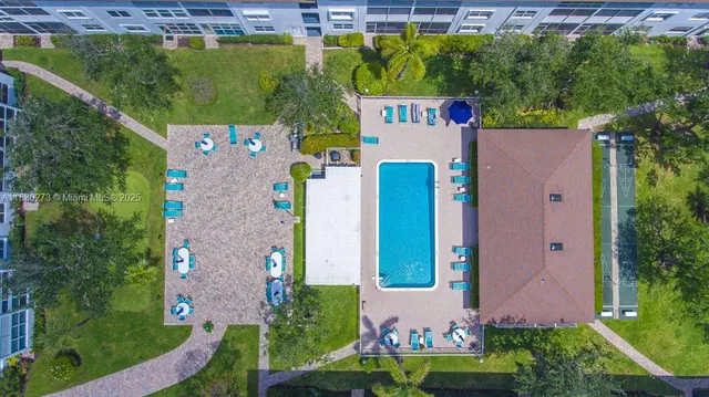 an aerial view of a house with a yard and pool