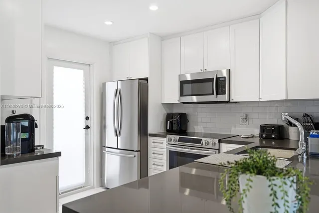 a kitchen with a sink stove and microwave