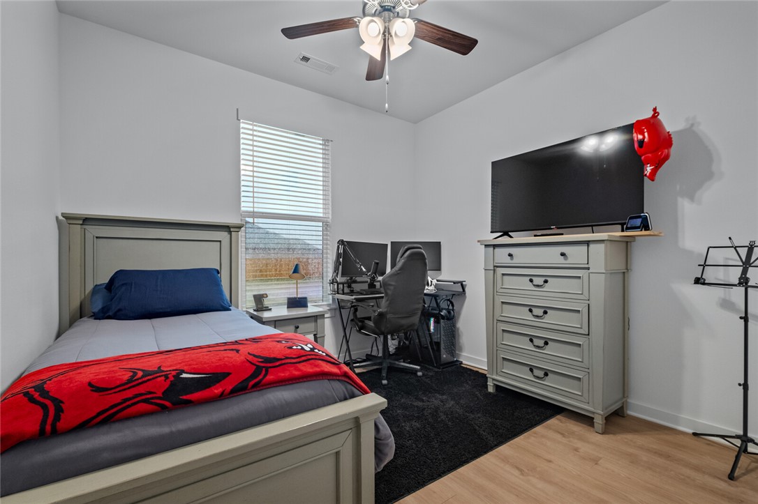 2105 Oliver Street Pea Ridge, AR 72751 - Photo 18 of 26 Bedroom featuring light wood-finish flooring, a ceiling fan with light fixture, and a window with blinds