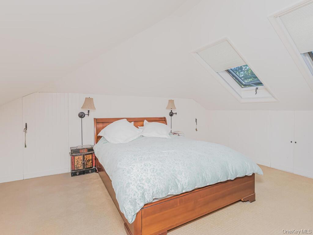 105 Douglas Road Chappaqua, NY 10514 - Photo 22 of 33 Primary Loft Bedroom with French Doors onto balcaony, featuring a skylight and lofted ceiling