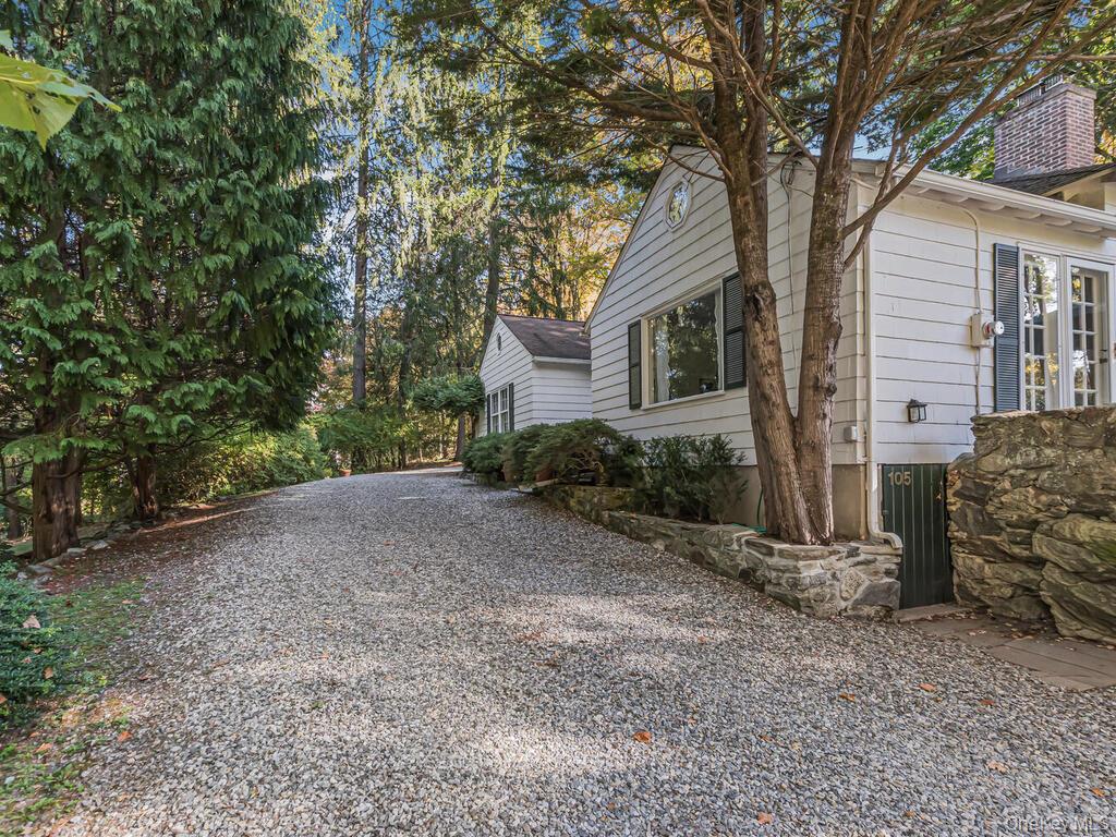 105 Douglas Road Chappaqua, NY 10514 - Photo 29 of 33 View of side of home featuring gravel driveway