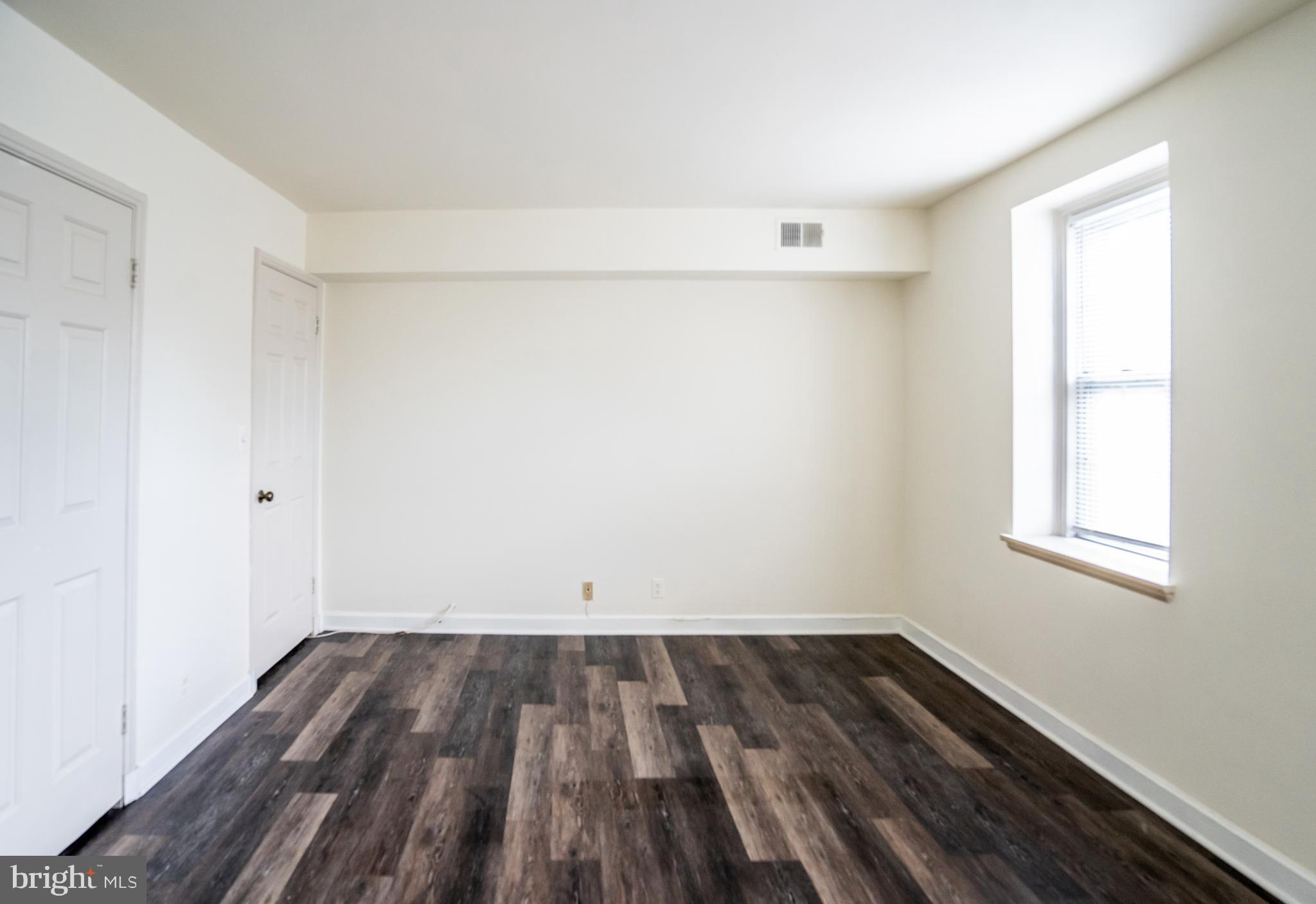 4814 30th Street South, Unit B1 Arlington, VA 22206 - Photo 14 of 18 an empty room with wooden floor and windows