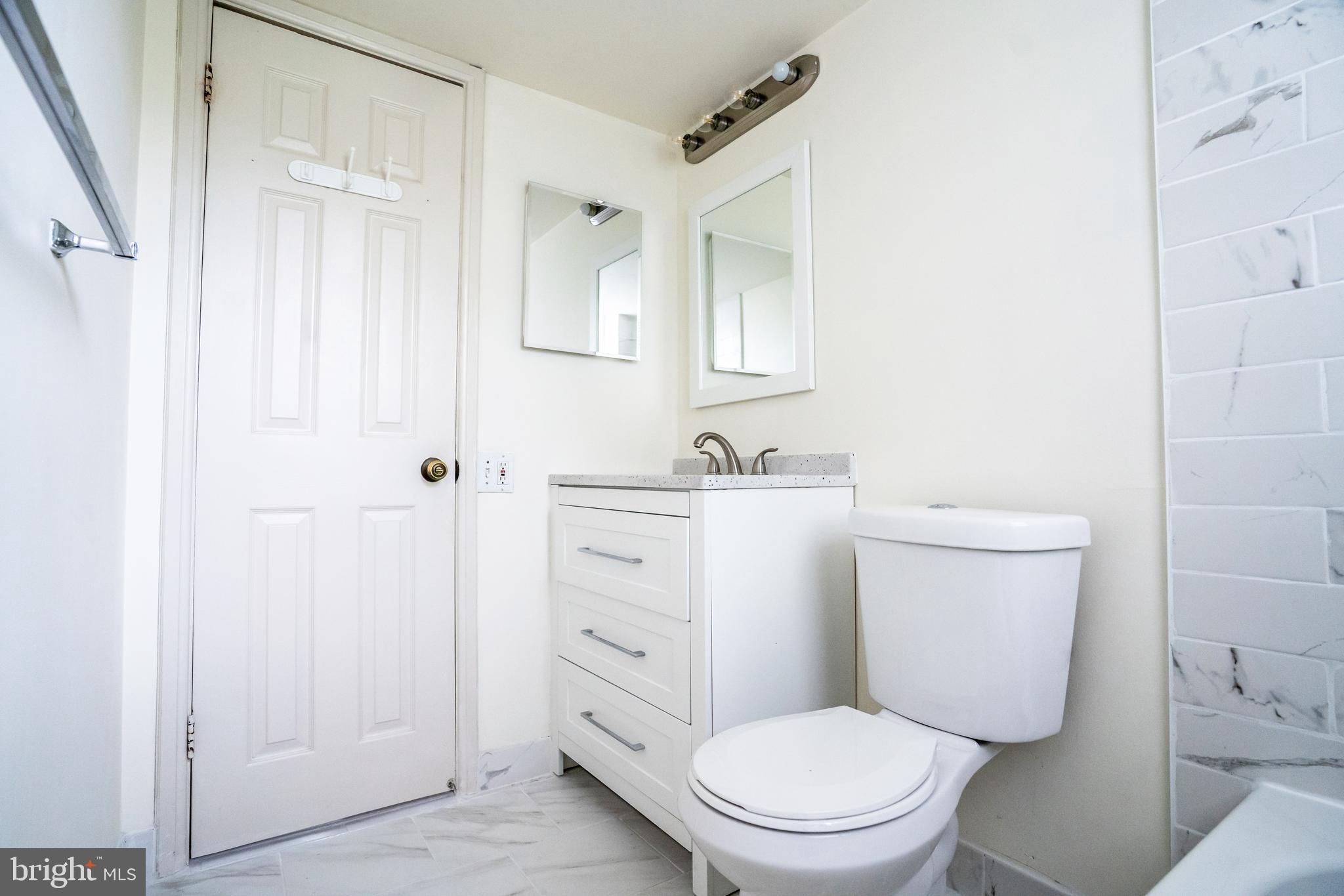 4814 30th Street South, Unit B1 Arlington, VA 22206 - Photo 15 of 18 a white toilet sitting next to a bathroom sink