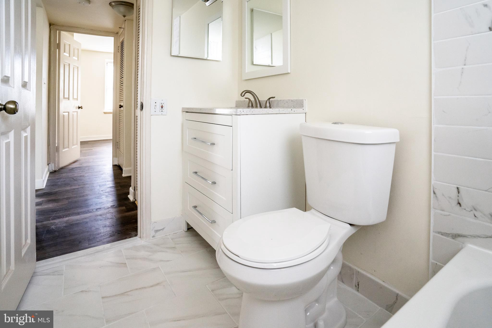 4814 30th Street South, Unit B1 Arlington, VA 22206 - Photo 16 of 18 a white toilet sitting next to a bathroom sink
