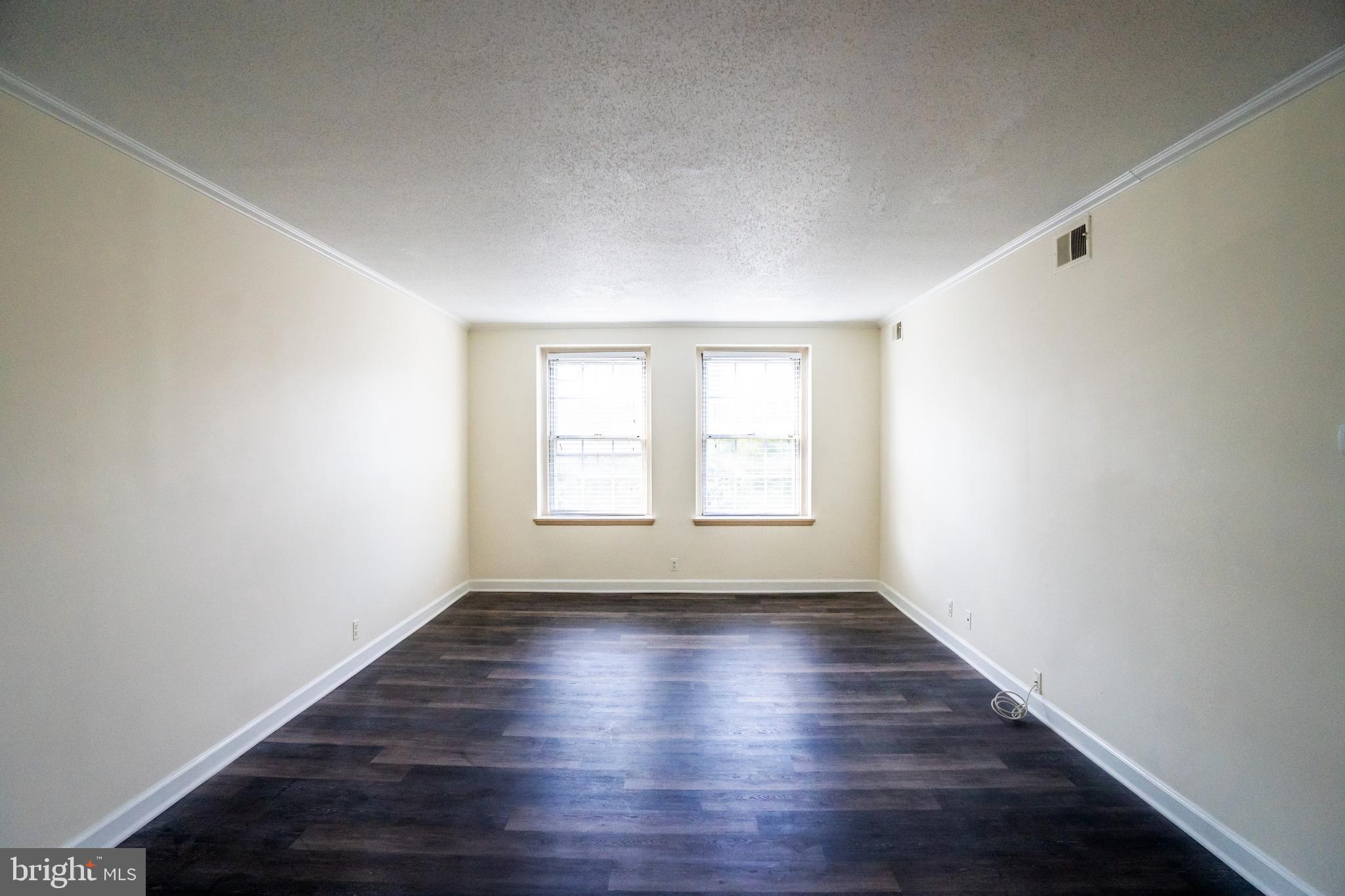 4814 30th Street South, Unit B1 Arlington, VA 22206 - Photo 3 of 18 an empty room with wooden floor and windows