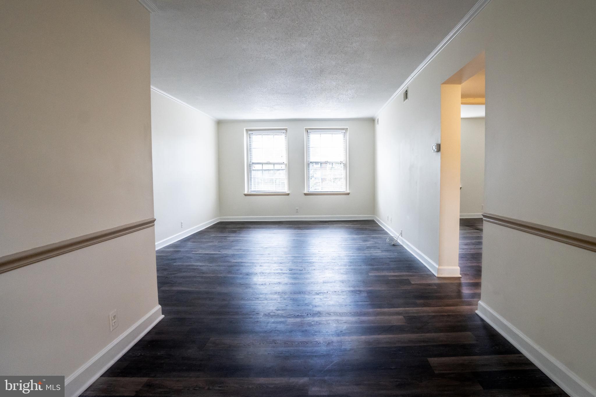 4814 30th Street South, Unit B1 Arlington, VA 22206 - Photo 4 of 18 a view of an empty room with wooden floor and a window