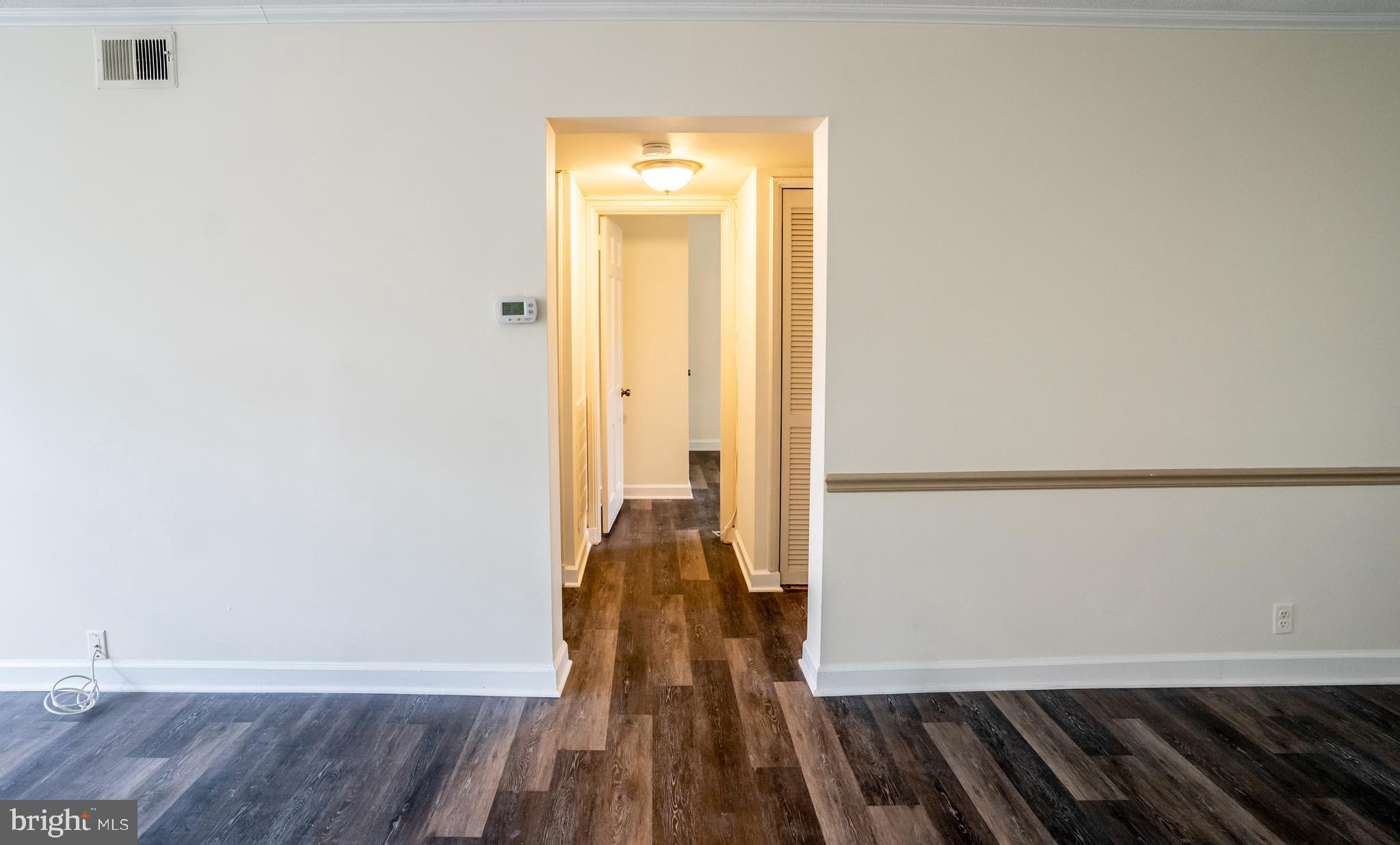 4814 30th Street South, Unit B1 Arlington, VA 22206 - Photo 7 of 18 a view of a hallway with wooden floor and a bathroom