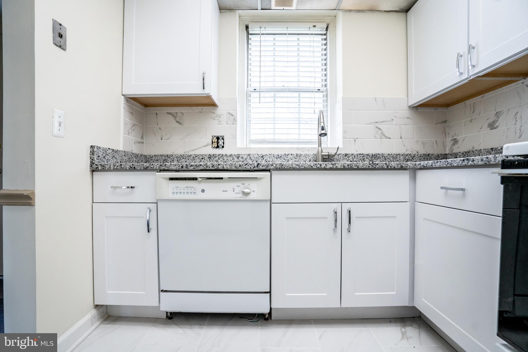 4814 30th Street South, Unit B1 Arlington, VA 22206 - Photo 8 of 18 a kitchen with granite countertop white cabinets and white appliances