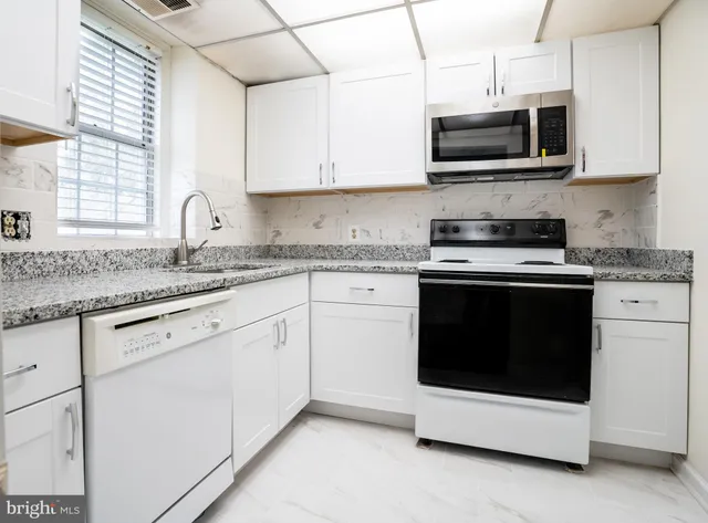 a bathroom with a granite countertop sink