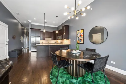 a dining room with furniture a rug and a chandelier