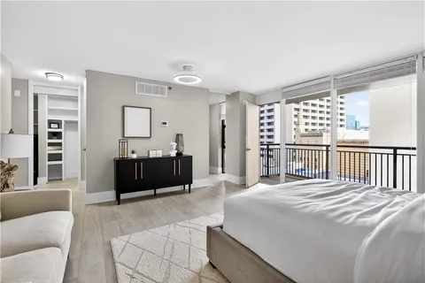 a bedroom with a bed and a large window