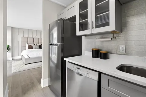 a kitchen with stainless steel appliances granite countertop a refrigerator and a sink