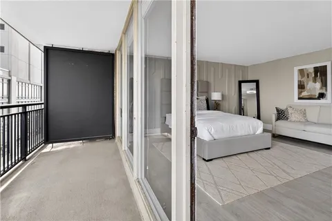 a bedroom with a bed and a painting on the wall