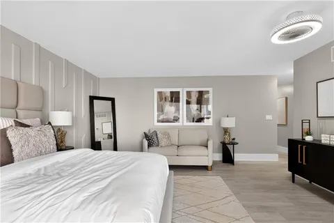a bedroom with a large bed and a couch