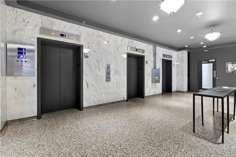 a view of a hallway with wooden shelves