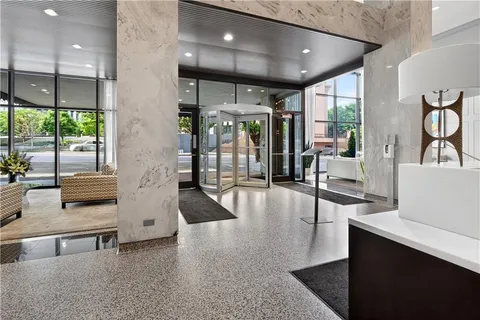 a lobby with furniture and large windows