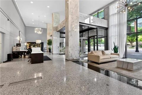 a living room with furniture and large windows