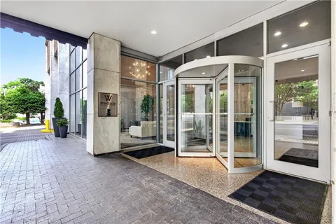 a view of a building with floor to ceiling windows and a table