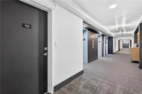 a view of a hallway with seating area