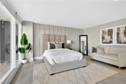 a bedroom with a large bed and a couch