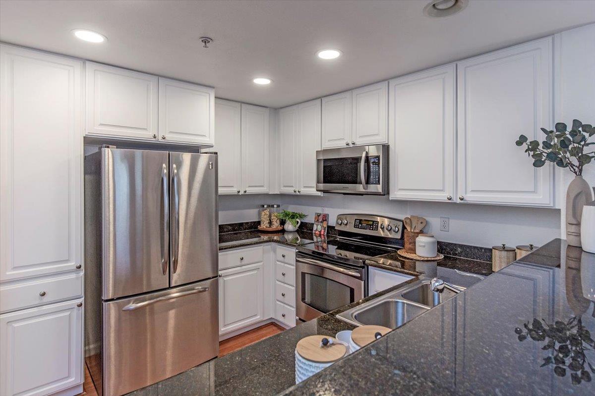 1883 Agnew Road, Unit 341 Santa Clara, CA 95054 - Photo 3 of 38 a kitchen with stainless steel appliances a refrigerator stove microwave and cabinets
