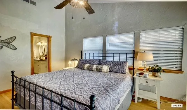 a bedroom with a bed and a chandelier