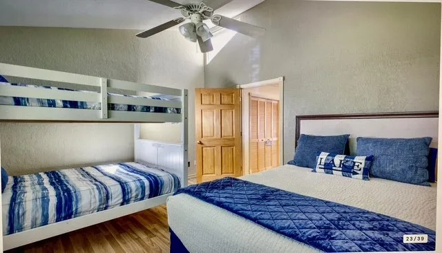 a bedroom with a large bed and a chandelier