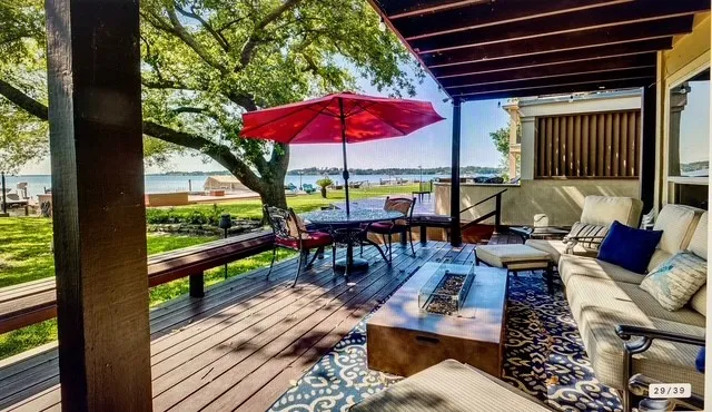 an outdoor sitting area with furniture and wooden floor