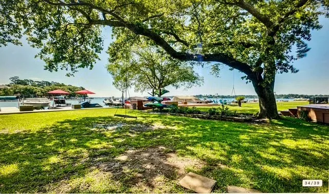 a view of yard with swimming pool and green space