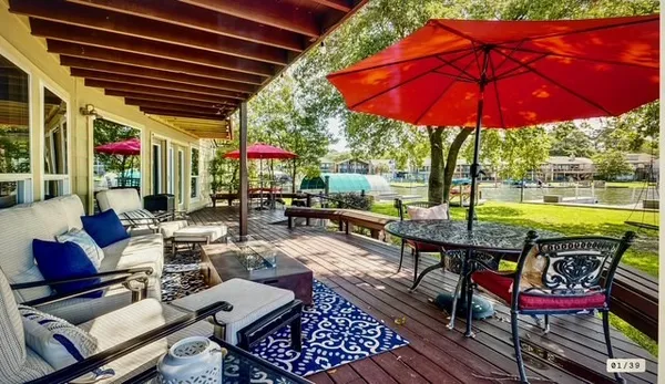 a patio with a table and chairs under an umbrella