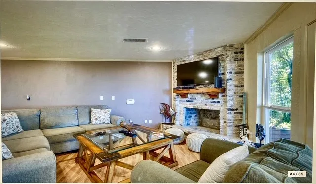 a living room with furniture a fireplace and a flat screen tv
